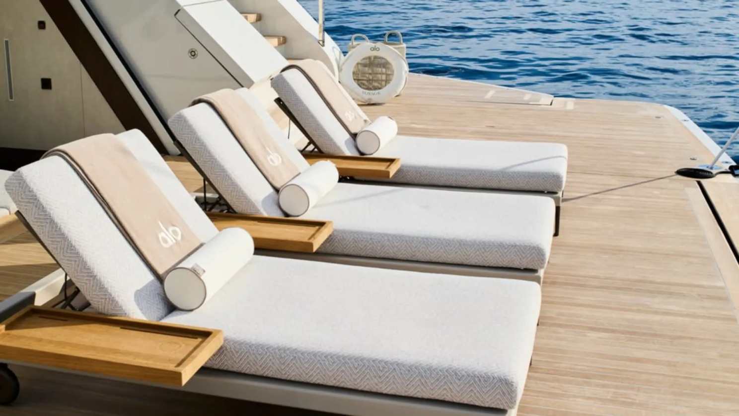 Alo-branded loungers overlooking the sea on the Alo Voyage yacht